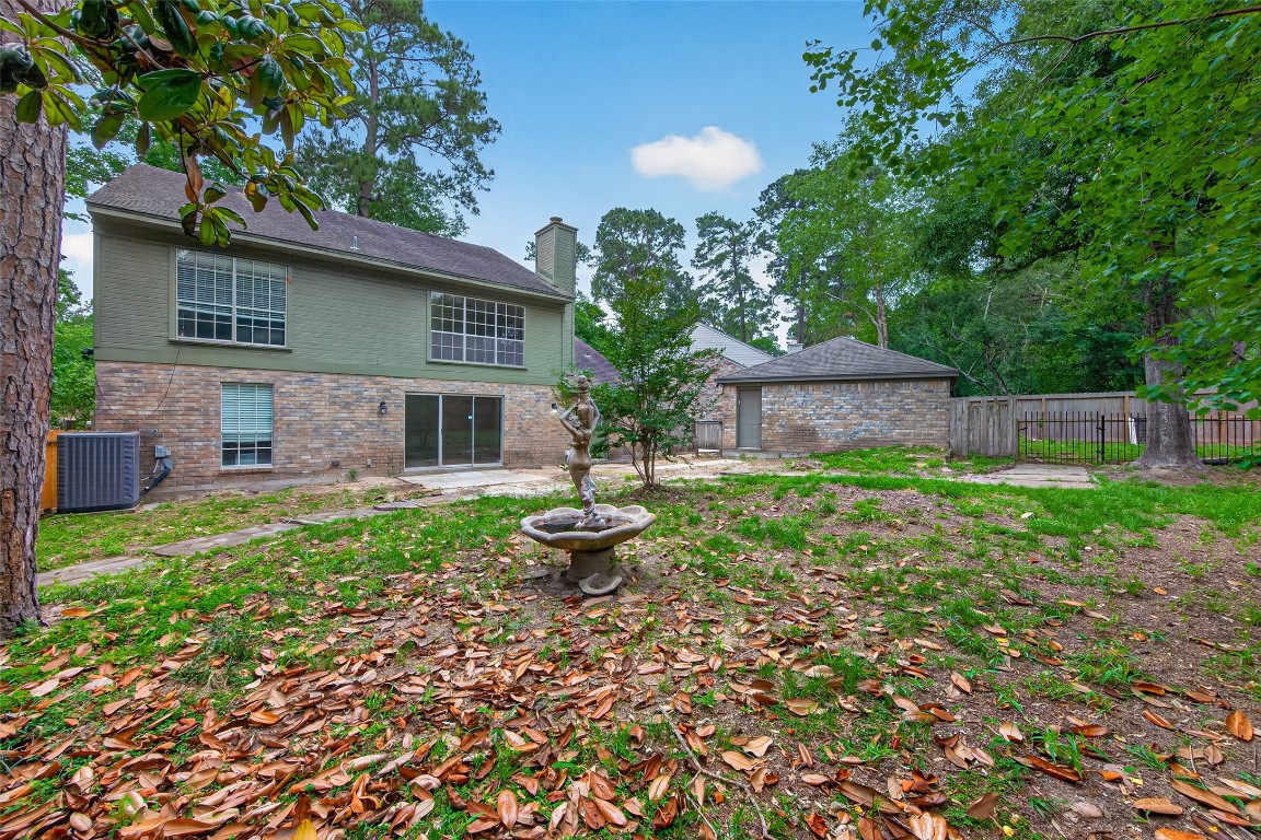 106 Breezy Point Place Spring, TX 77381 - Photo 37 of 37 Unique backyard retreat features multi-level deck, fountains, stone pathways, and tranquil outdoor living.