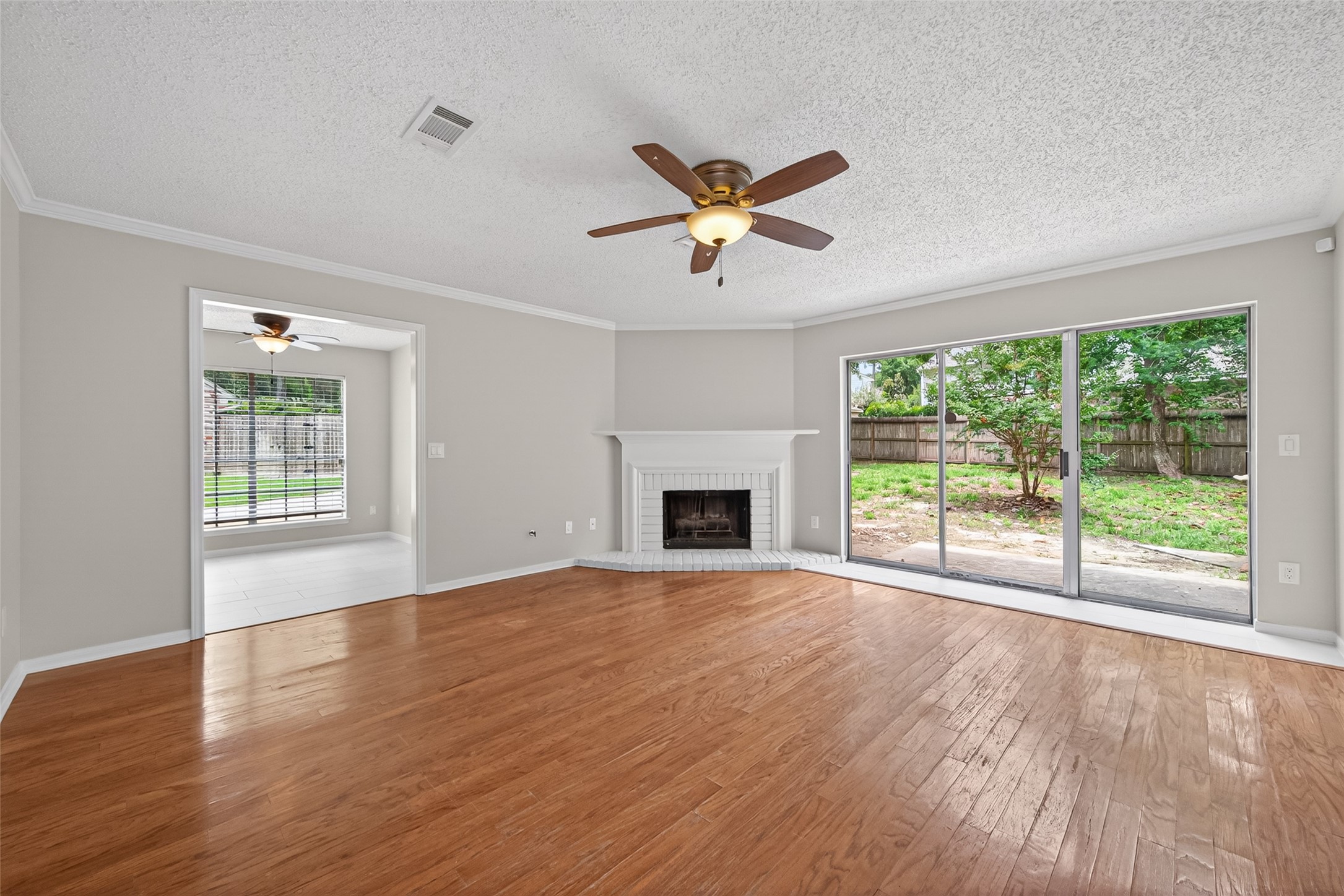 106 Breezy Point Place Spring, TX 77381 - Photo 6 of 37 Spacious living room features a cozy fireplace and abundant natural light.