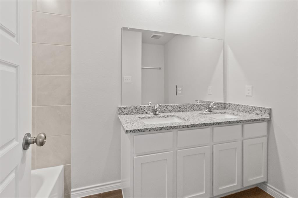 1128 Runway Road Fort Worth, TX 76131 - Photo 13 of 18 a bathroom with a granite countertop sink and a mirror
