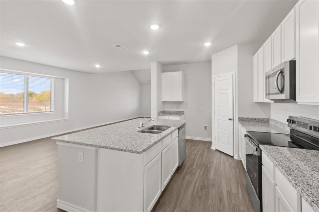 1128 Runway Road Fort Worth, TX 76131 - Photo 5 of 18 a kitchen with a stove sink and cabinets