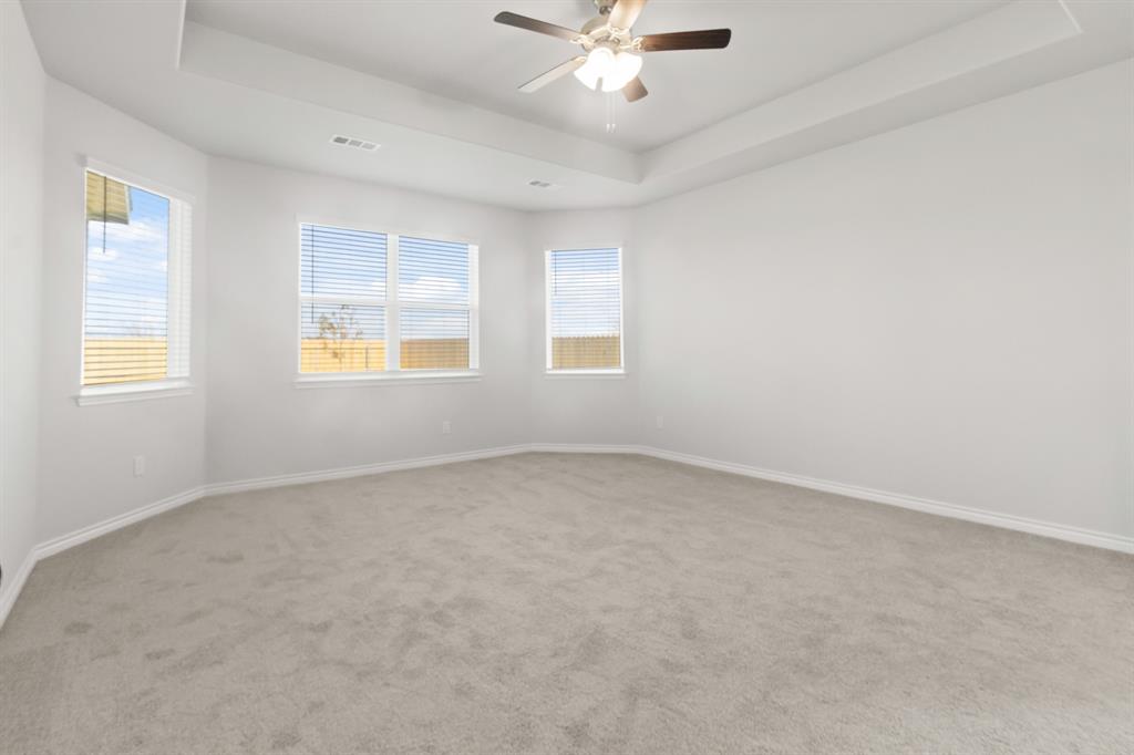 1128 Runway Road Fort Worth, TX 76131 - Photo 8 of 18 an empty room with a window and a fan