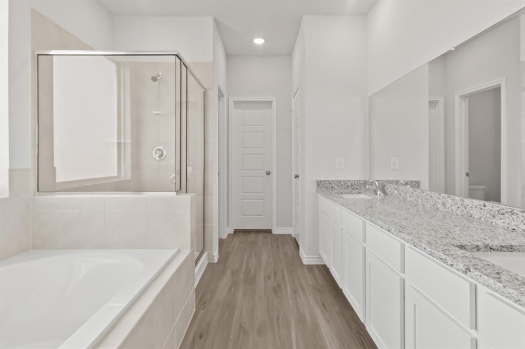 1128 Runway Road Fort Worth, TX 76131 - Photo 9 of 18 a bathroom with a granite countertop sink a bathtub and a shower