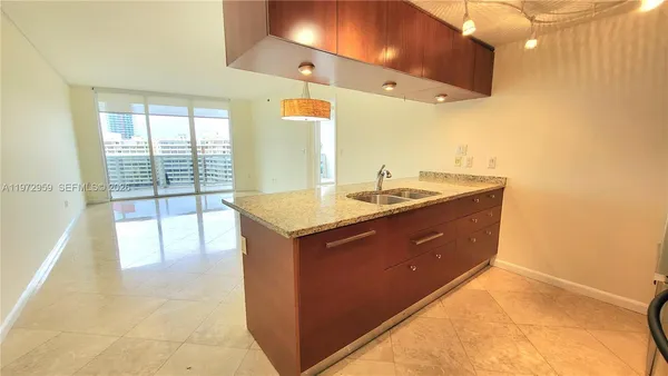 a bathroom with a sink a vanity and a large mirror