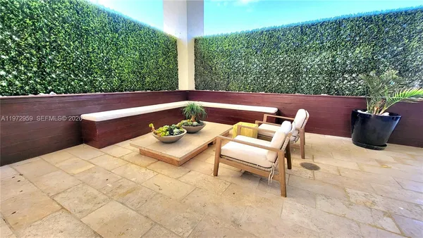 a view of a patio with couches chairs and potted plants