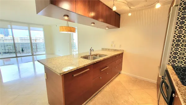 a bathroom with a granite countertop sink a large mirror and a shower