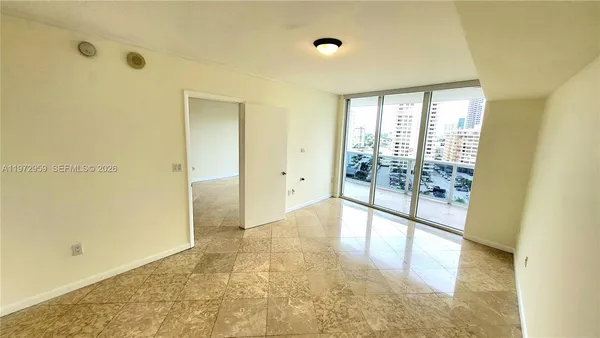 a view of an empty room with glass door