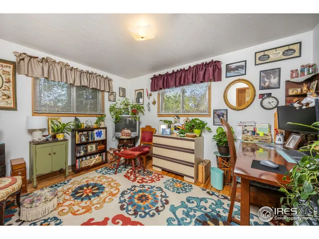 a living room filled with furniture and a wooden floor