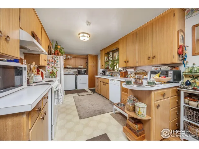 a kitchen with a sink appliances and cabinets
