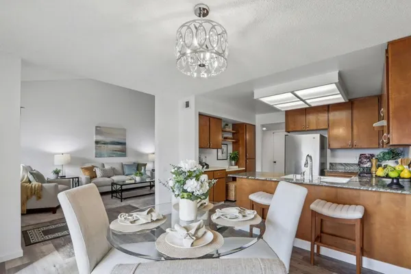 a living room with furniture and a kitchen view