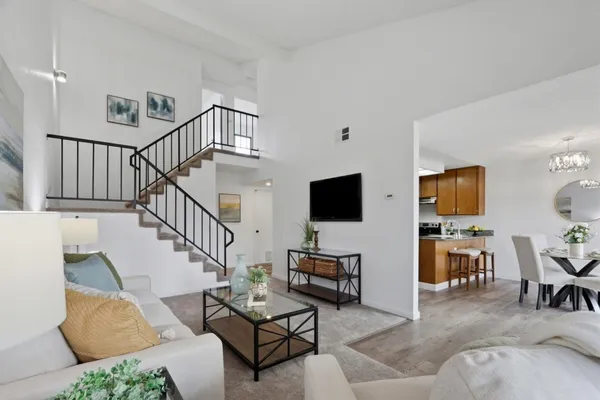 a living room with furniture and a flat screen tv with wooden floor
