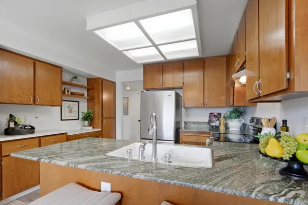 a kitchen with stainless steel appliances granite countertop sink stove and cabinets