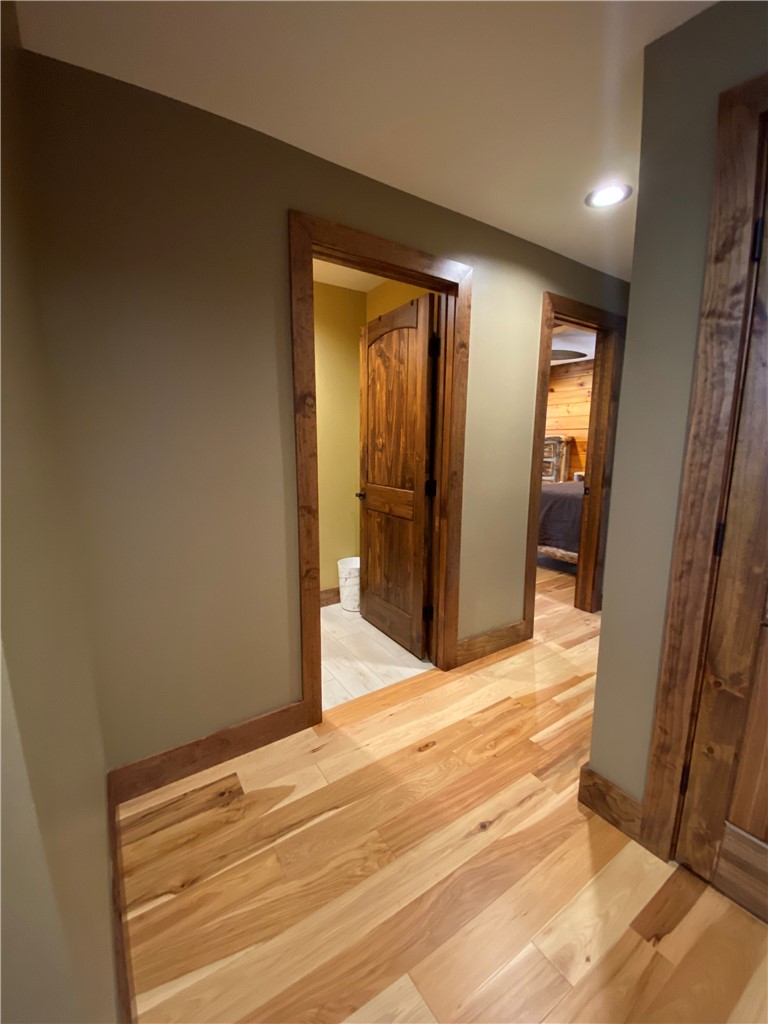 128 McAlister Road West Union, SC 29696 - Photo 24 of 40 Natural hardwood flooring guides the way through this well-lit interior hallway.