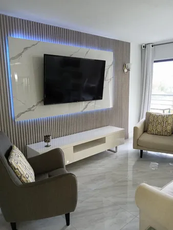 a view of a bedroom with furniture and wooden floor