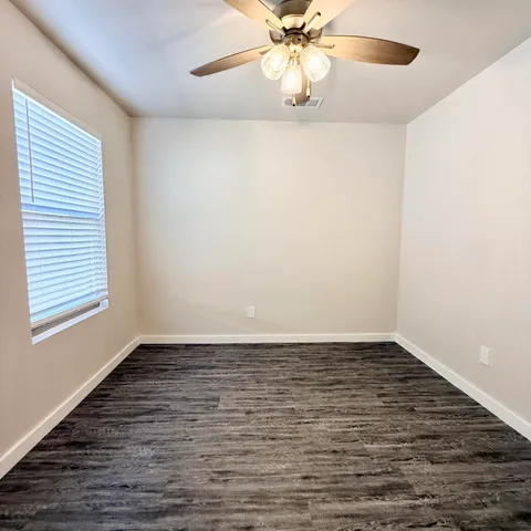 a bathroom with a granite countertop sink a toilet and a bathtub