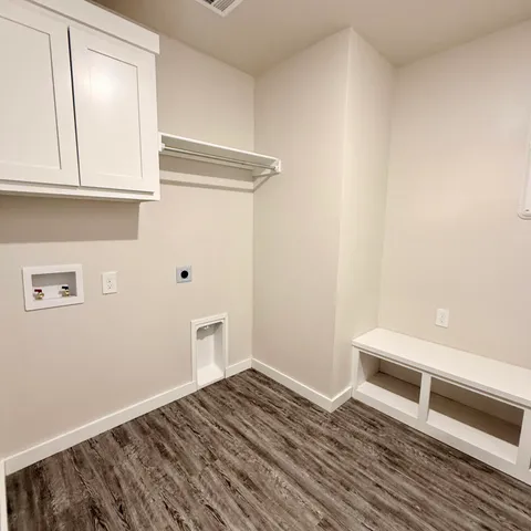 a view of kitchen with granite countertop wooden floors and wide window