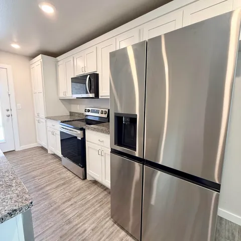 a kitchen with a sink and wooden floor