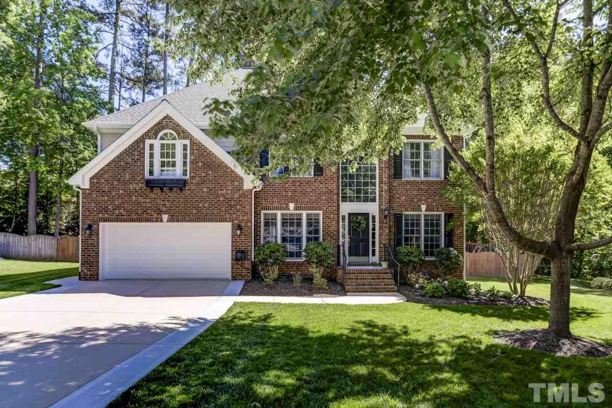 8401 Wapello Lane Raleigh, NC 27613 - Photo 1 of 26 a front view of a house with a yard and garage