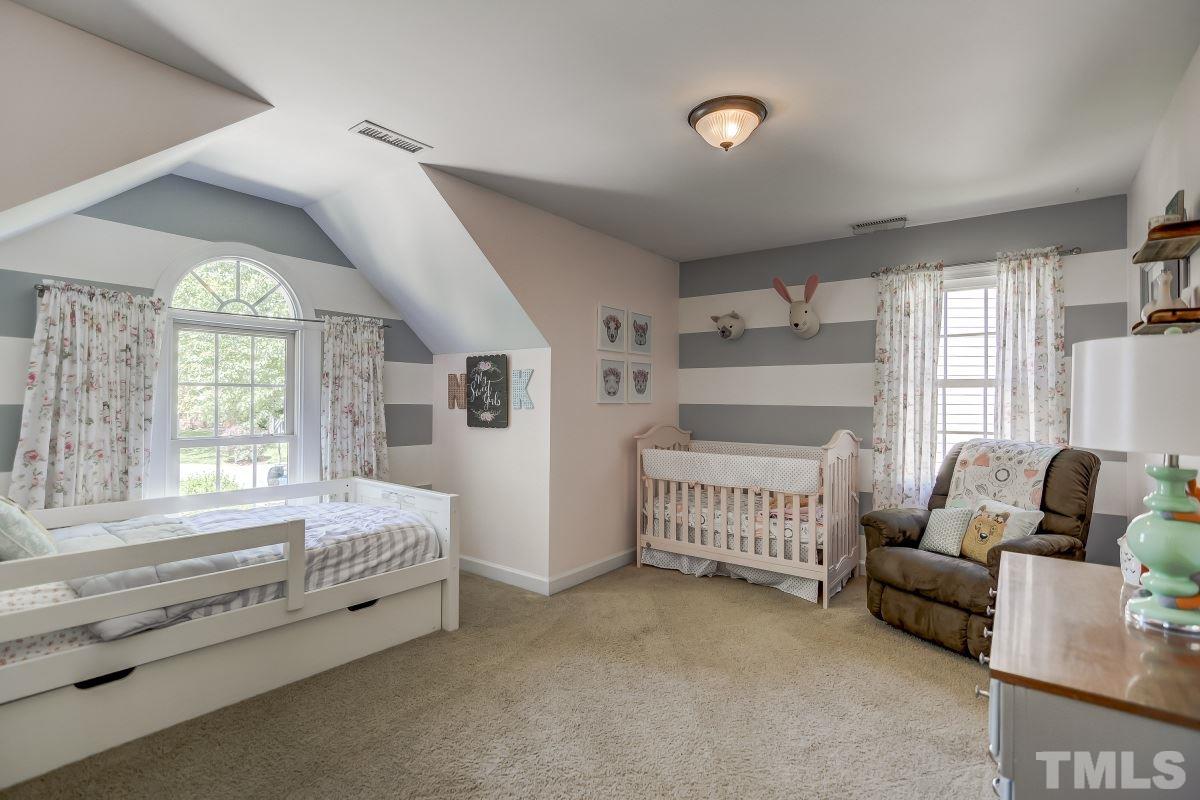 8401 Wapello Lane Raleigh, NC 27613 - Photo 17 of 26 a spacious bedroom with a bed and a couch