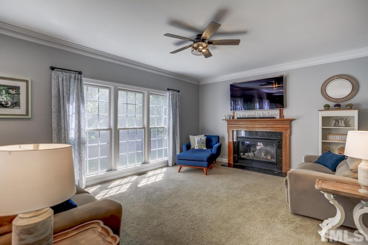 8401 Wapello Lane Raleigh, NC 27613 - Photo 6 of 26 a living room with furniture and a fireplace