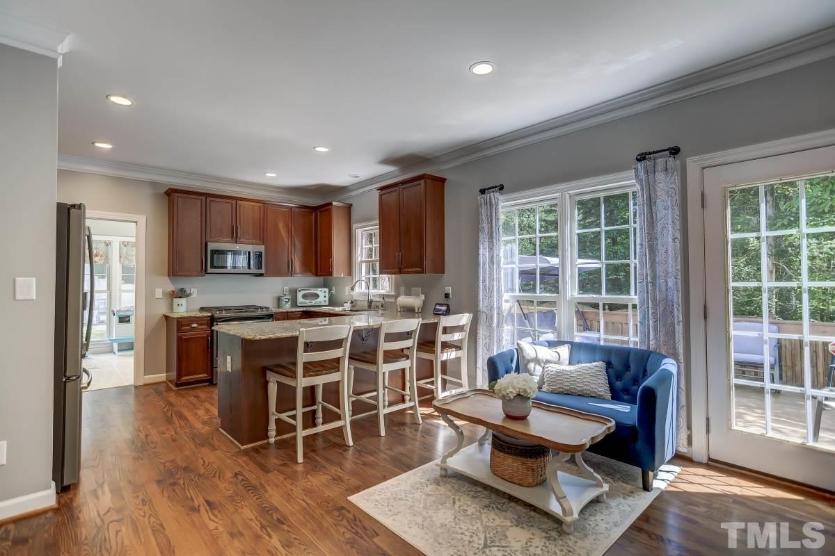 8401 Wapello Lane Raleigh, NC 27613 - Photo 7 of 26 a living room with stainless steel appliances granite countertop furniture a rug kitchen view and a refrigerator