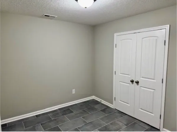 an empty room with closet area