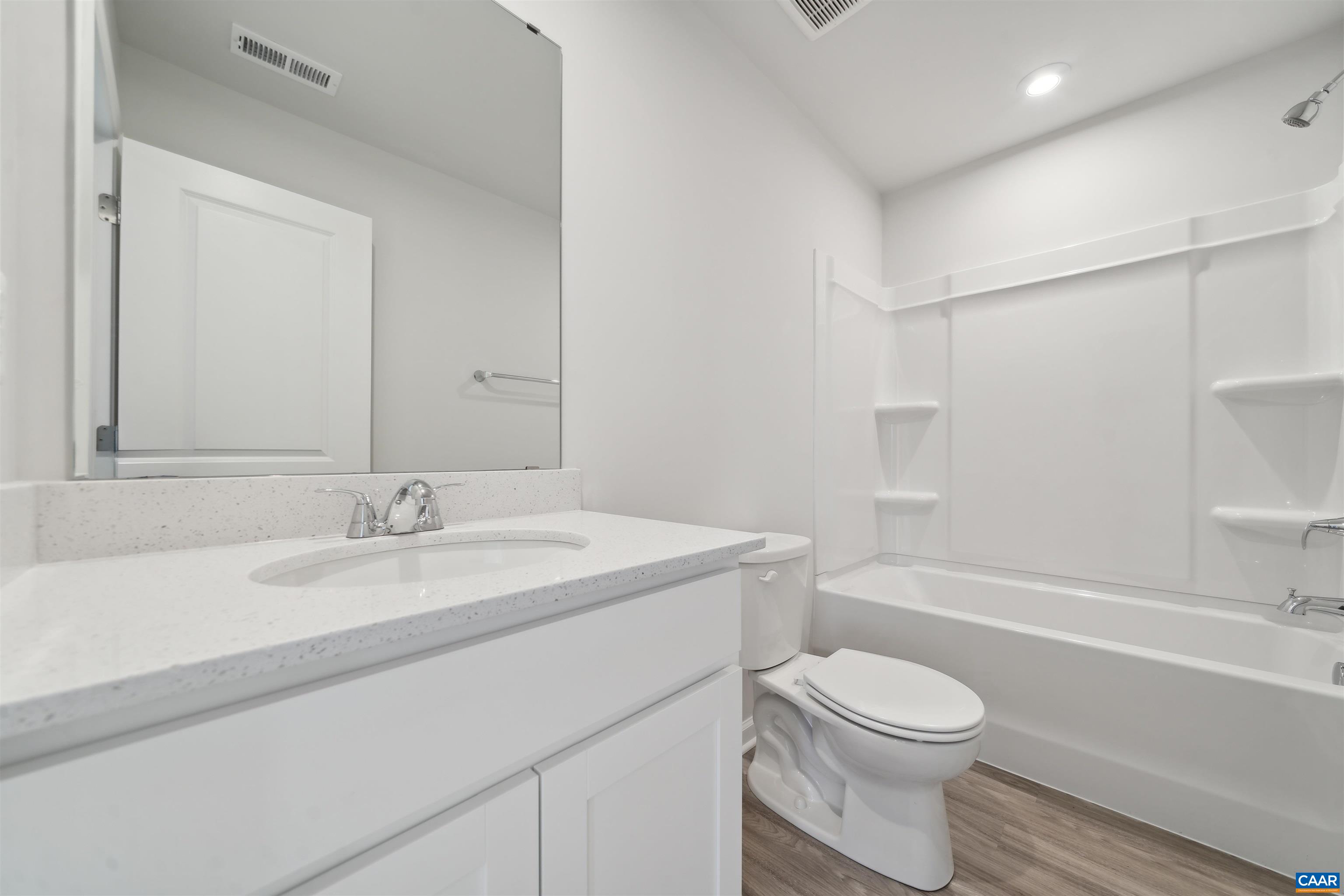 259 Trailfork Road Barboursville, VA 22923 - Photo 14 of 40 a bathroom with a granite countertop sink toilet a mirror and bathtub