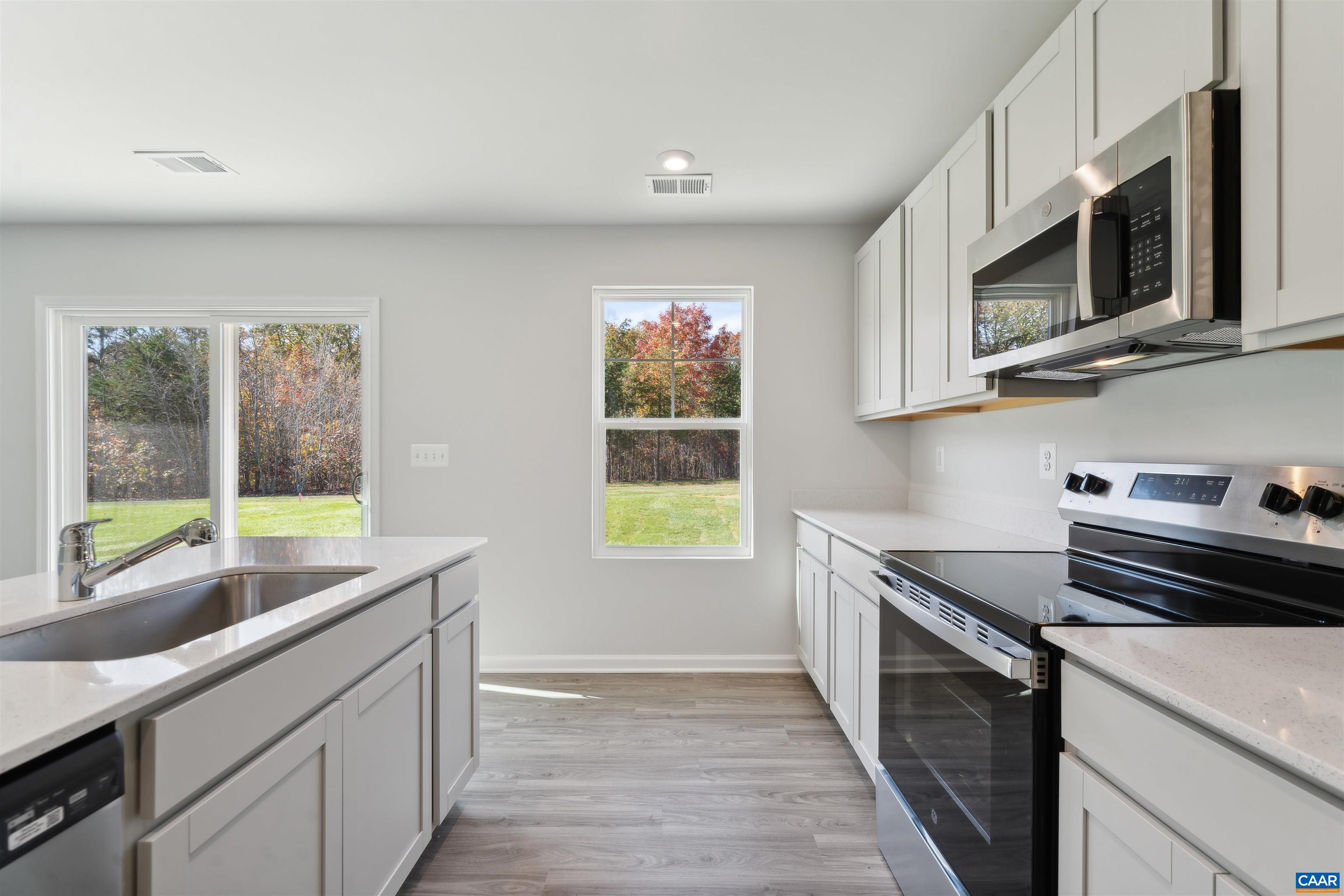 259 Trailfork Road Barboursville, VA 22923 - Photo 10 of 40 a kitchen with stainless steel appliances granite countertop a sink and a stove