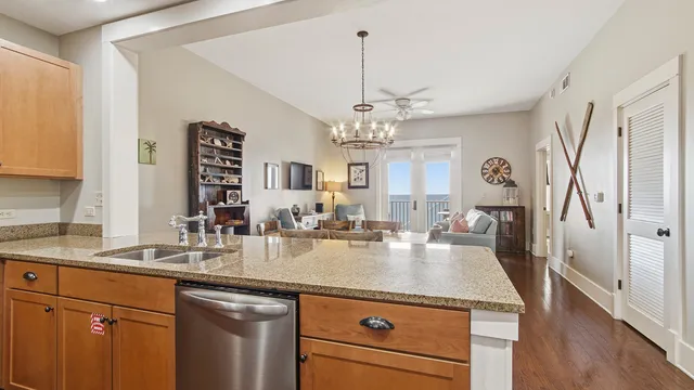 a large kitchen with stainless steel appliances granite countertop a lot of counter space and wooden floor