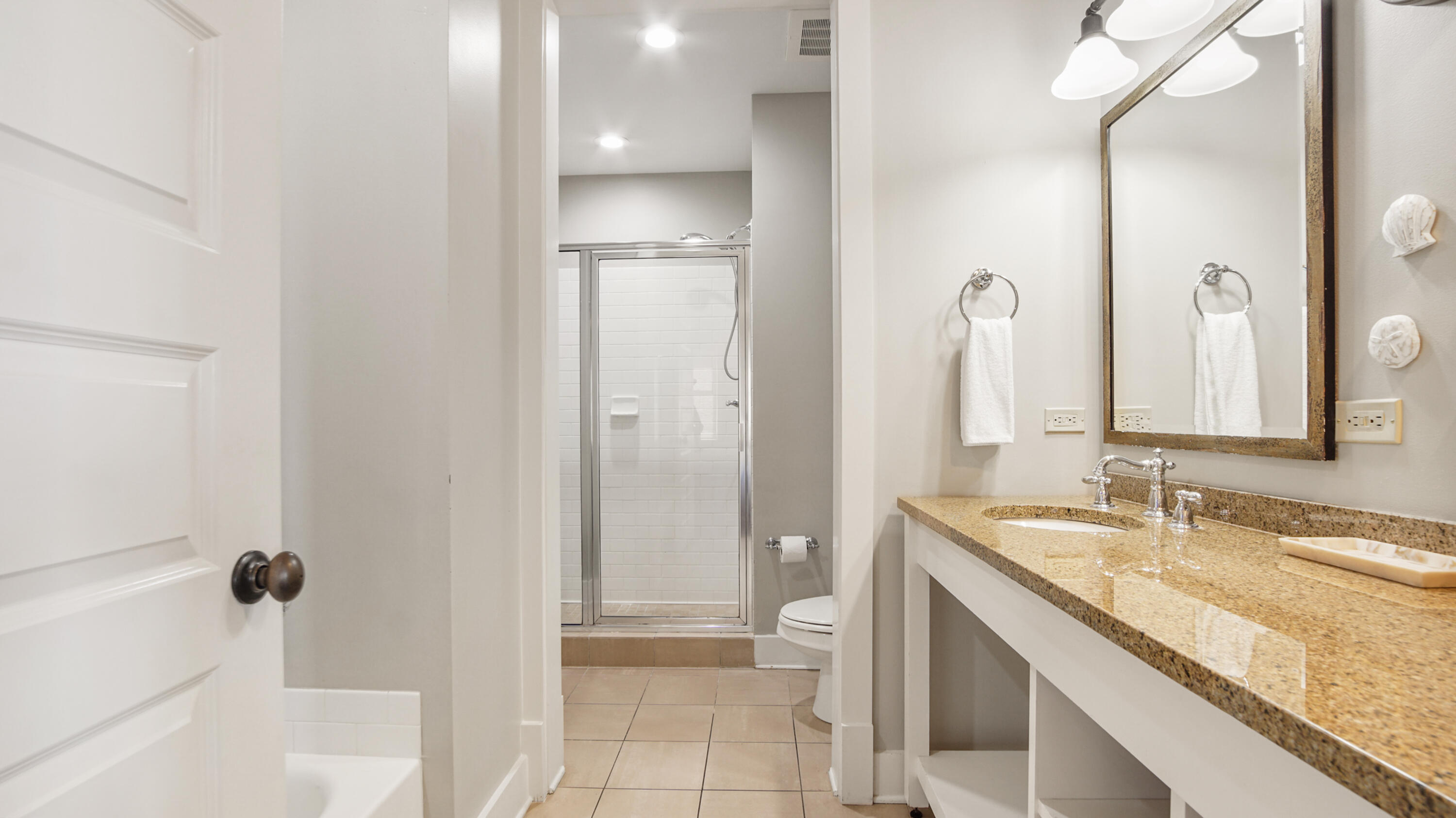 2050 West County Highway 30A, Unit M1408 Santa Rosa Beach, FL 32459 - Photo 17 of 25 a bathroom with a granite countertop sink a toilet and shower