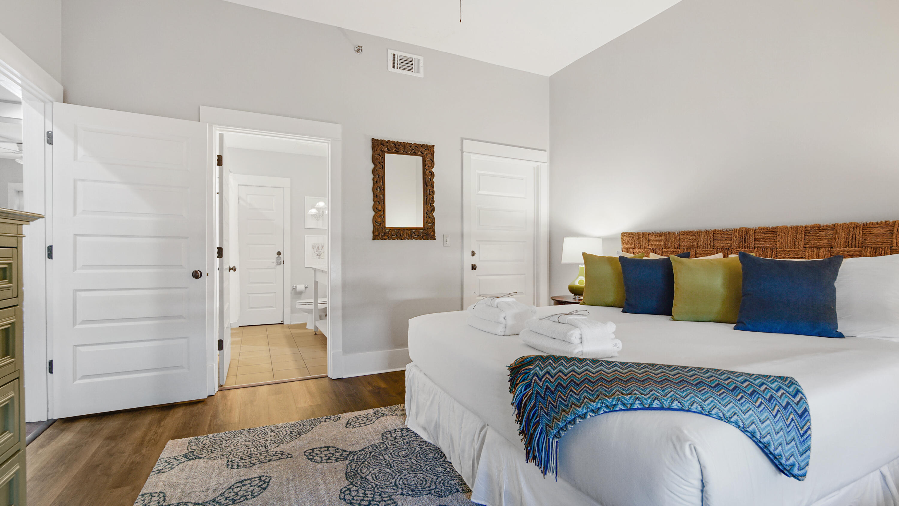 2050 West County Highway 30A, Unit M1408 Santa Rosa Beach, FL 32459 - Photo 19 of 25 a spacious bedroom with a bed and wooden floor