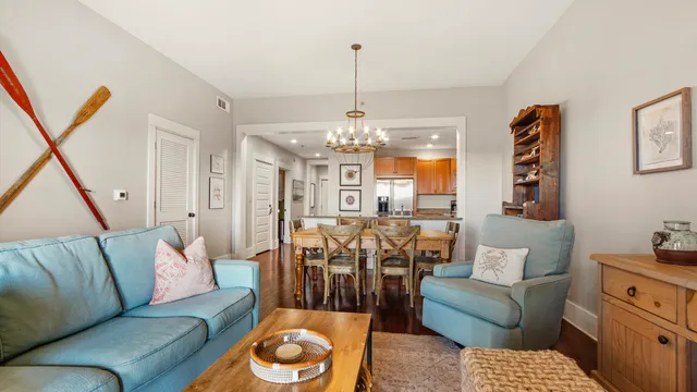 a living room with furniture and a chandelier