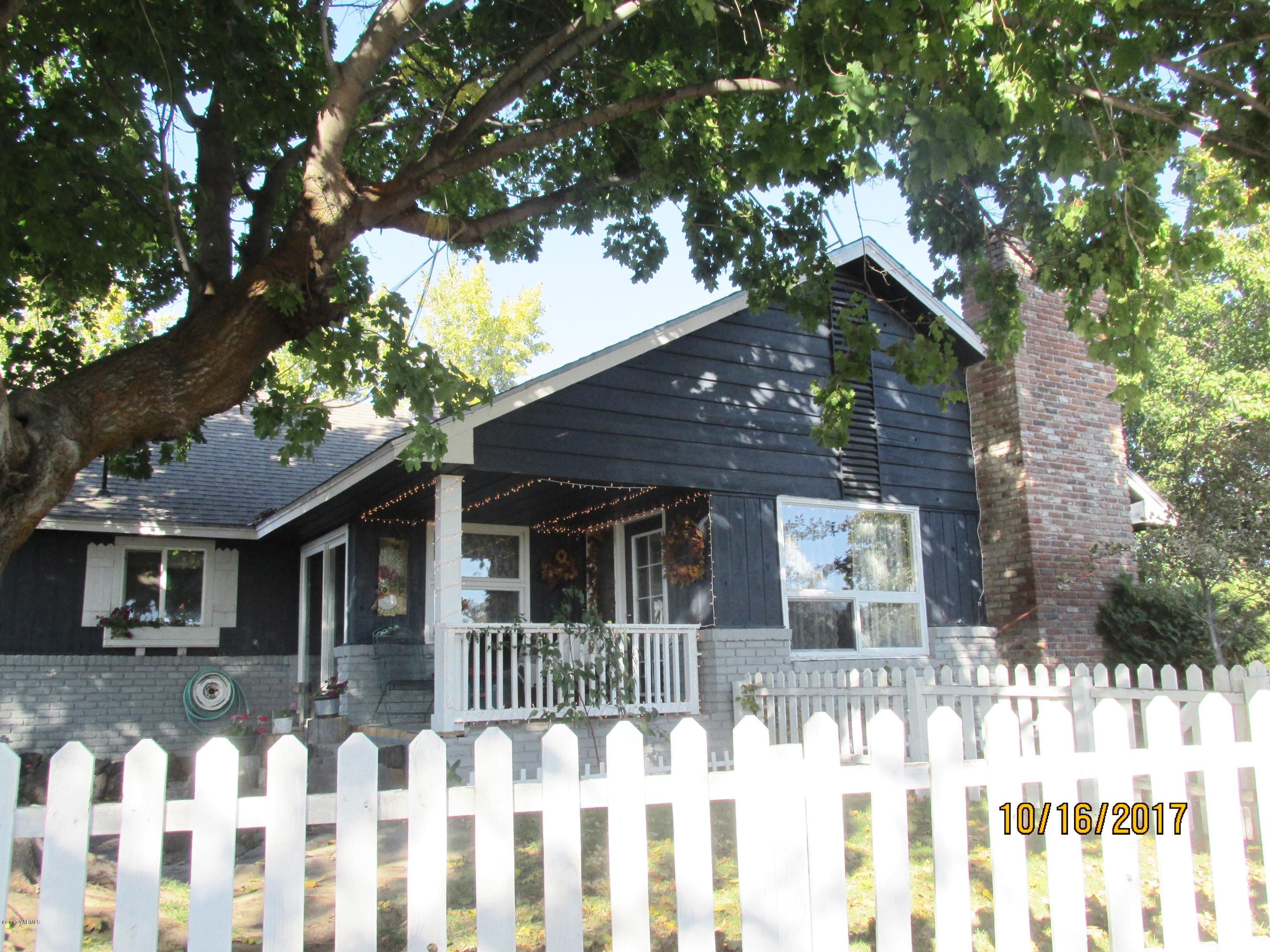 a front view of white house with a small yard