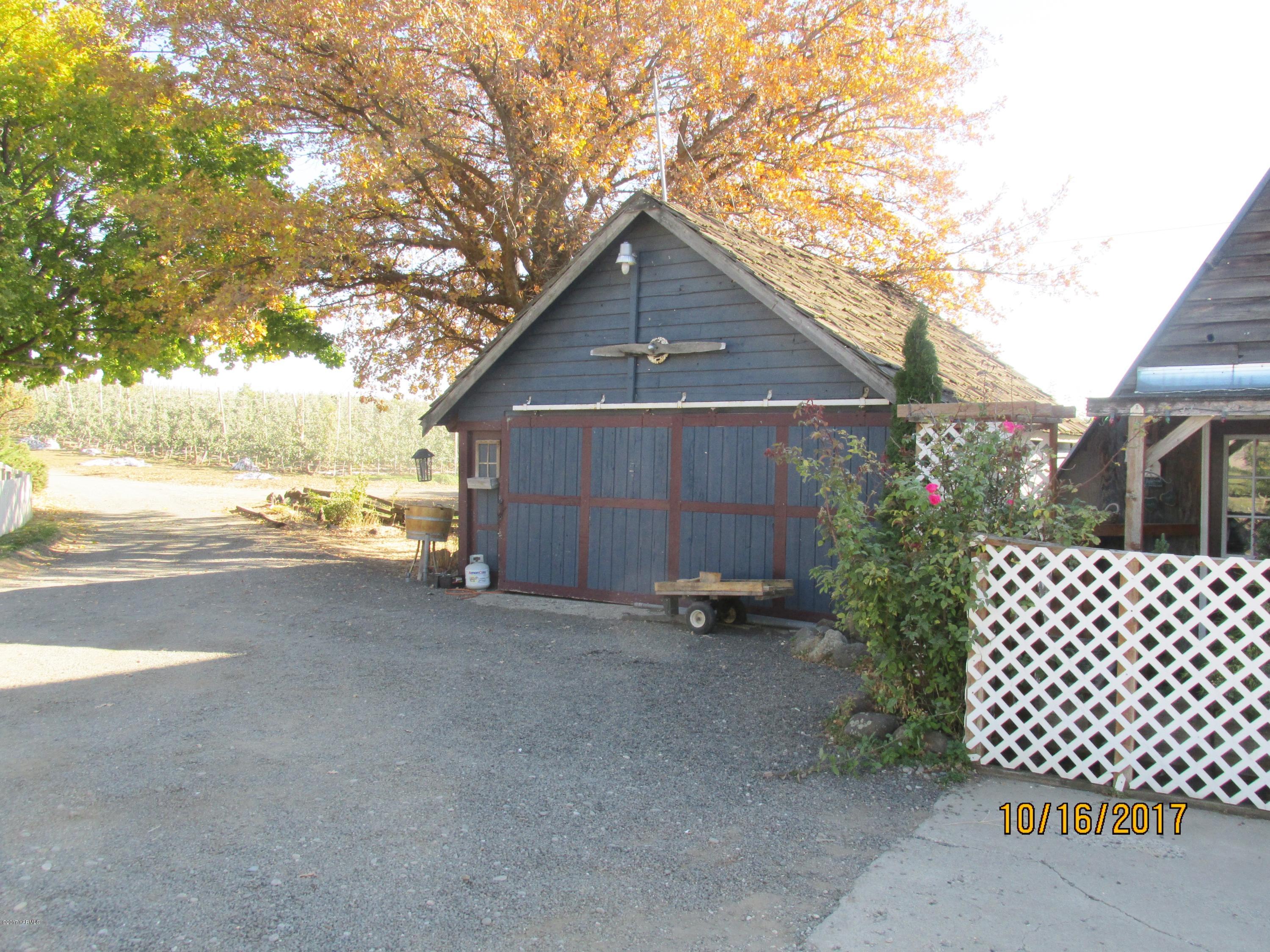 1172 North Cowiche Road Tieton, WA 98947 - Photo 17 of 46 a view of a house with wooden fence next to a road