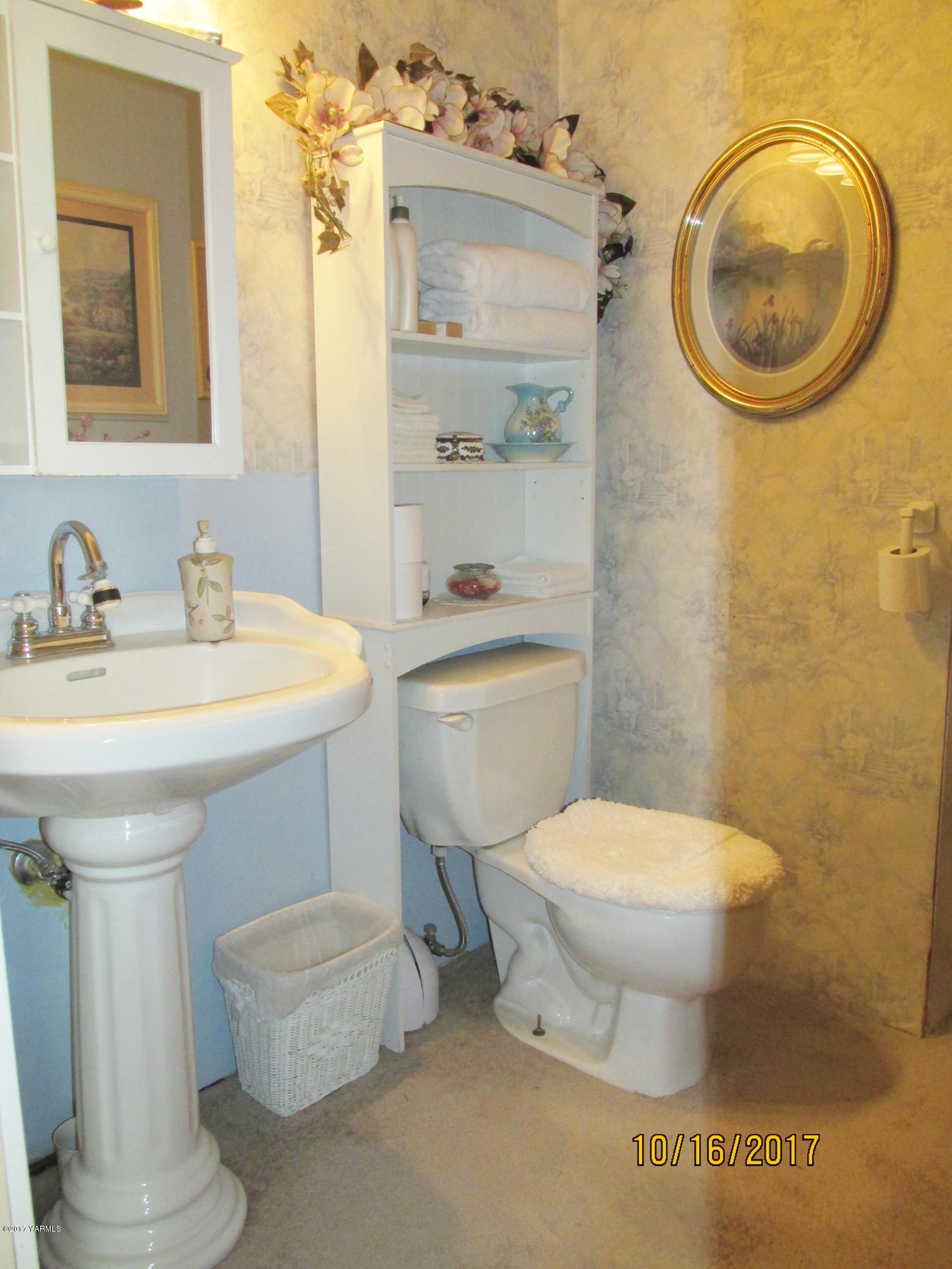 1172 North Cowiche Road Tieton, WA 98947 - Photo 45 of 46 a bathroom with a sink toilet mirror and vanity