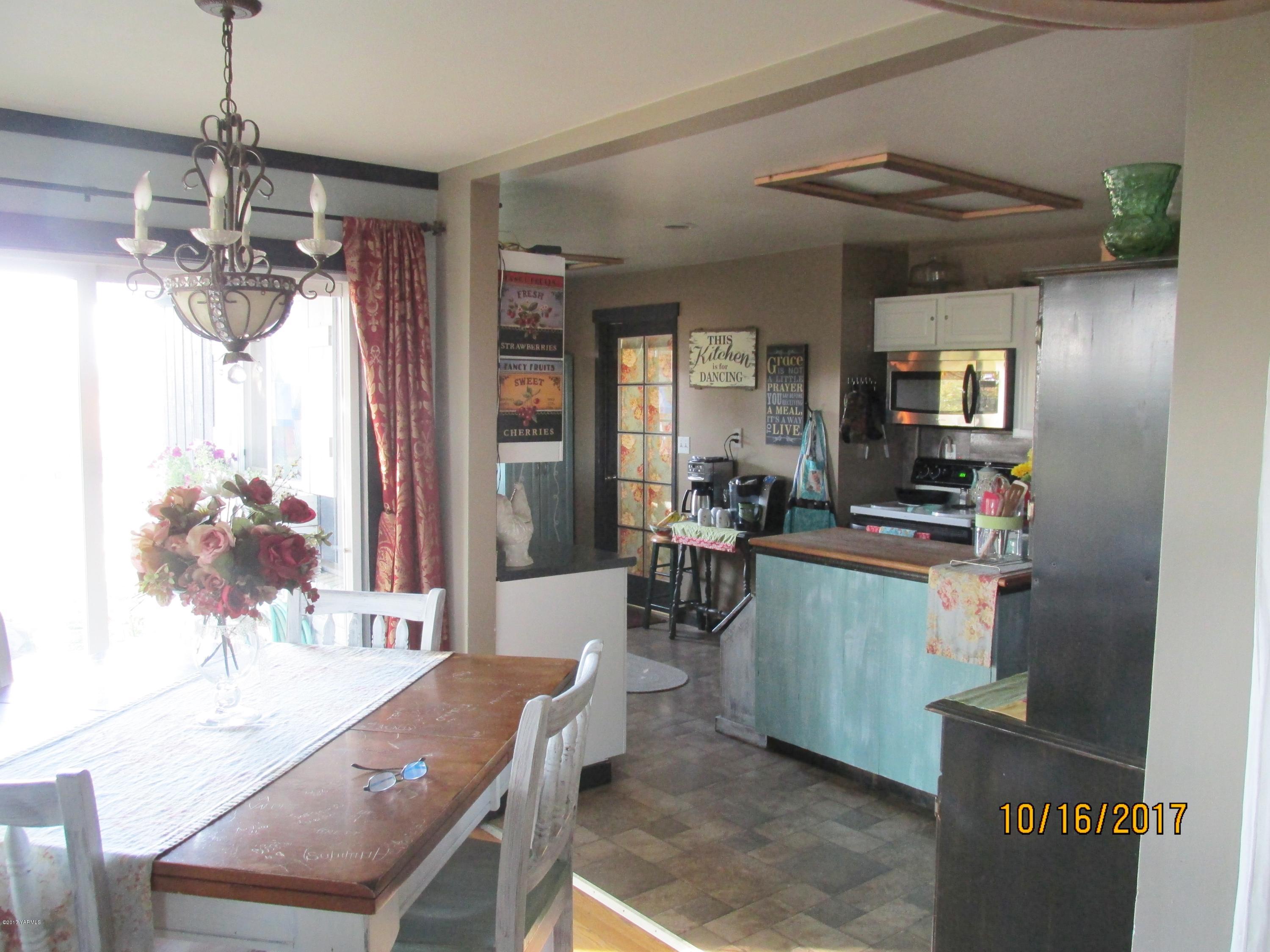 1172 North Cowiche Road Tieton, WA 98947 - Photo 8 of 46 a view of a dining room with furniture window and wooden floor