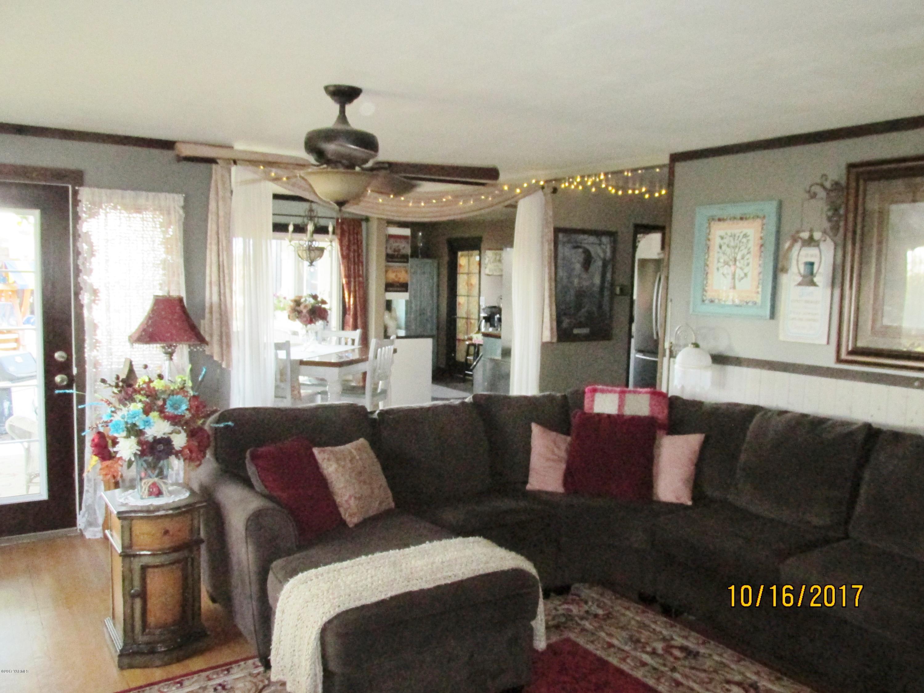 1172 North Cowiche Road Tieton, WA 98947 - Photo 9 of 46 a living room with furniture and a chandelier