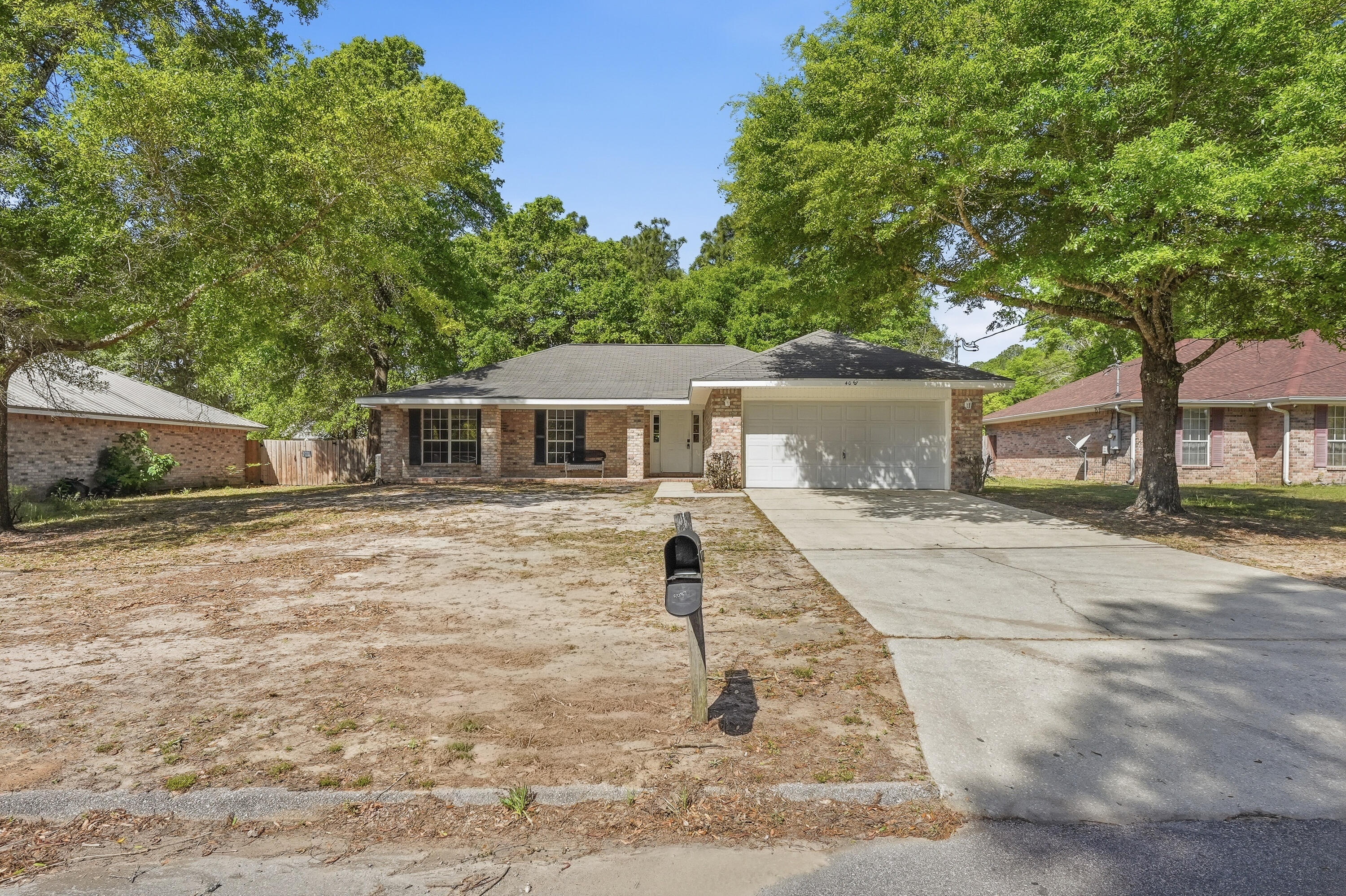 4087 Audiss Road Milton, FL 32583 - Photo 5 of 34 a front view of a house with a yard and trees
