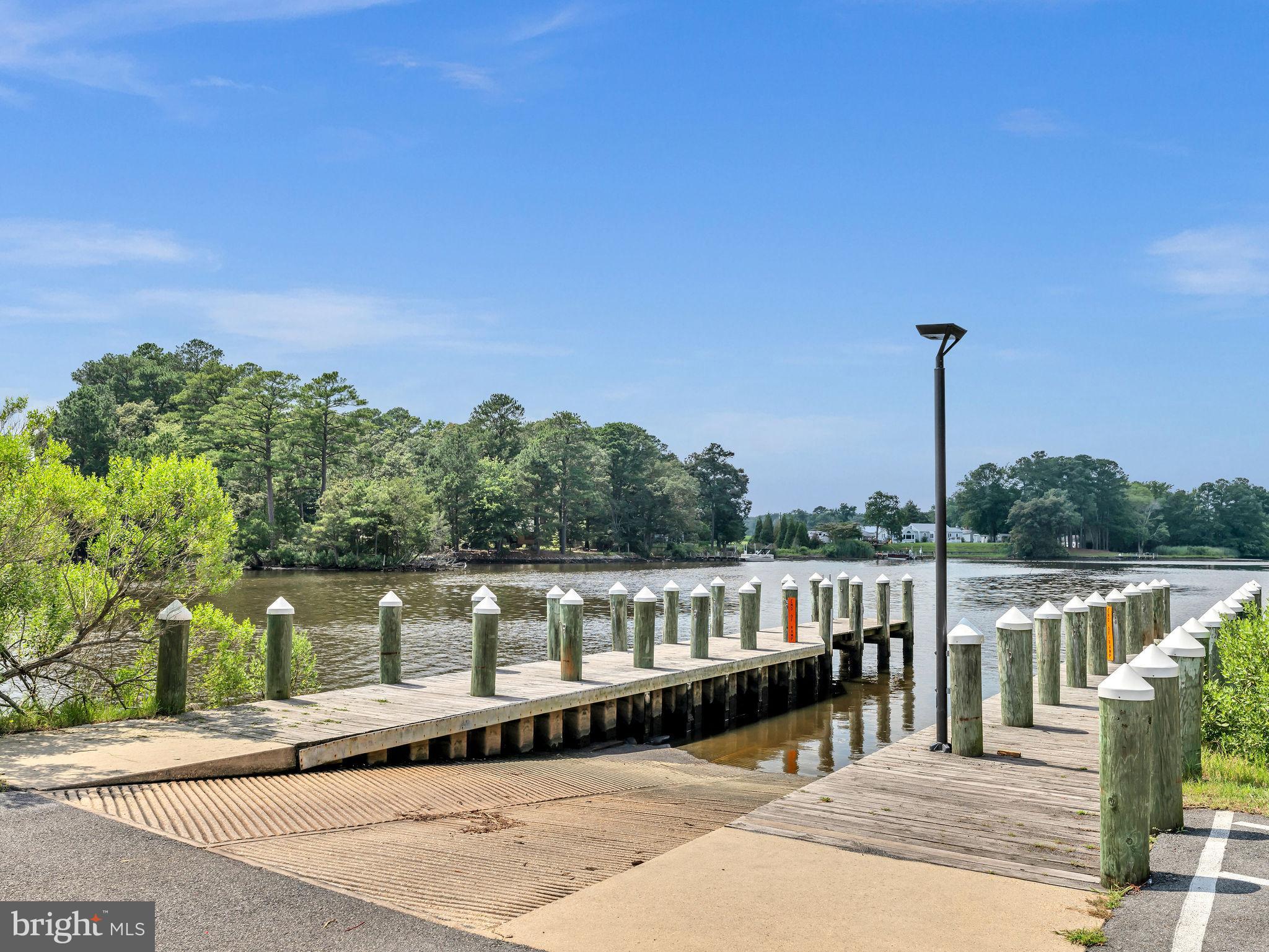 12623 Shell Mill Road, Unit 67 Bishopville, MD 21813 - Photo 12 of 22 a balcony with wooden floor and fence