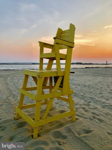a view of a lake with a table and chairs