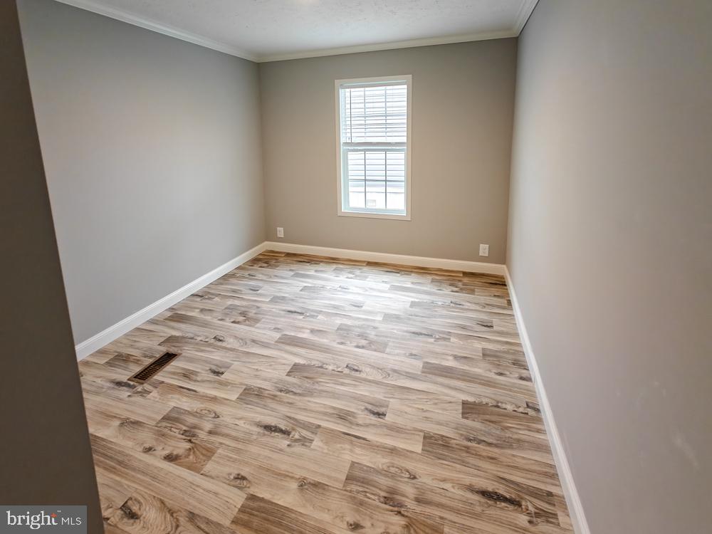 12623 Shell Mill Road, Unit 67 Bishopville, MD 21813 - Photo 8 of 22 an empty room with windows