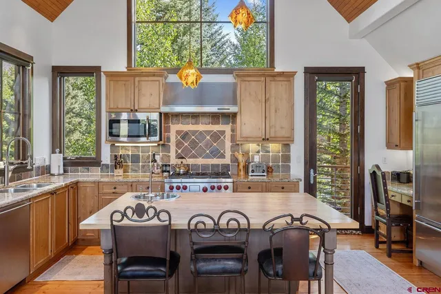 a view of a kitchen with a table and chairs in it