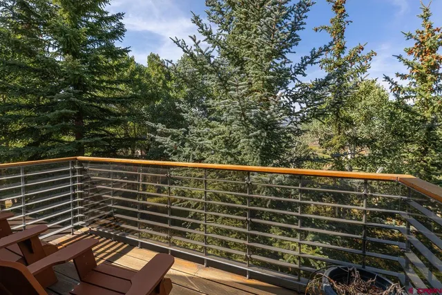 a view of balcony with wooden floor and fence