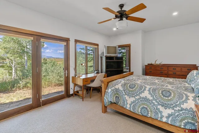 a bedroom with a bed and a large window