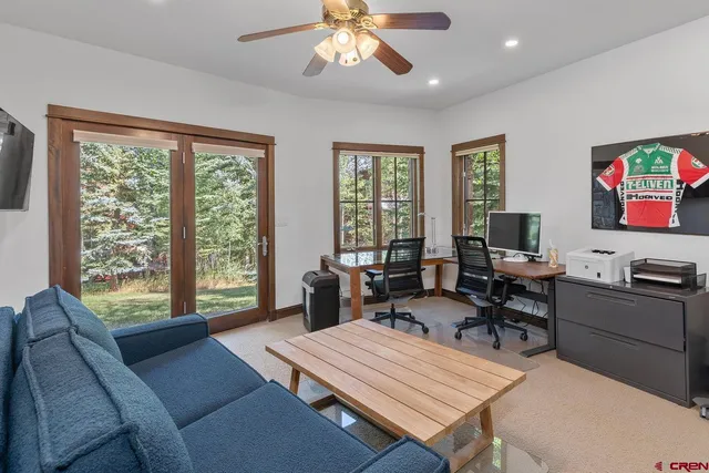 a living room with furniture a table and a large window