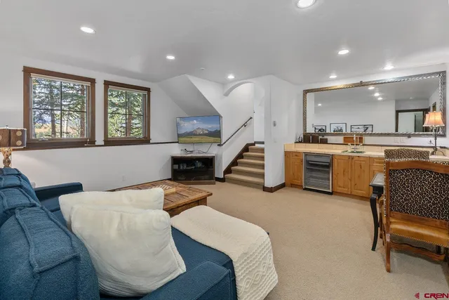 a living room with furniture and a kitchen