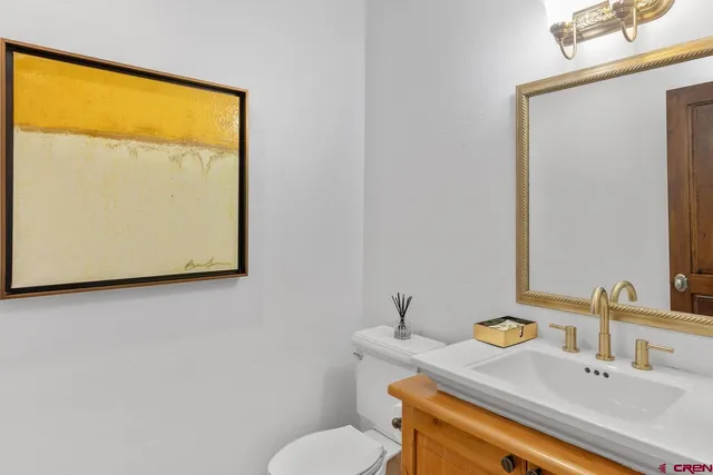 a bathroom with a sink a mirror and a toilet