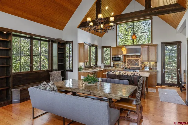 a dining room with furniture and wooden floor