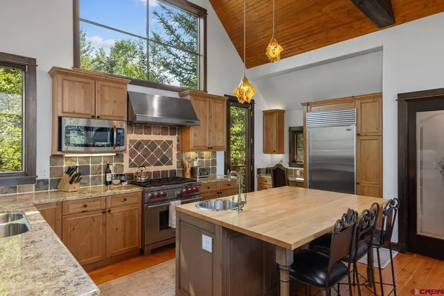 a kitchen with a stove a sink and a refrigerator