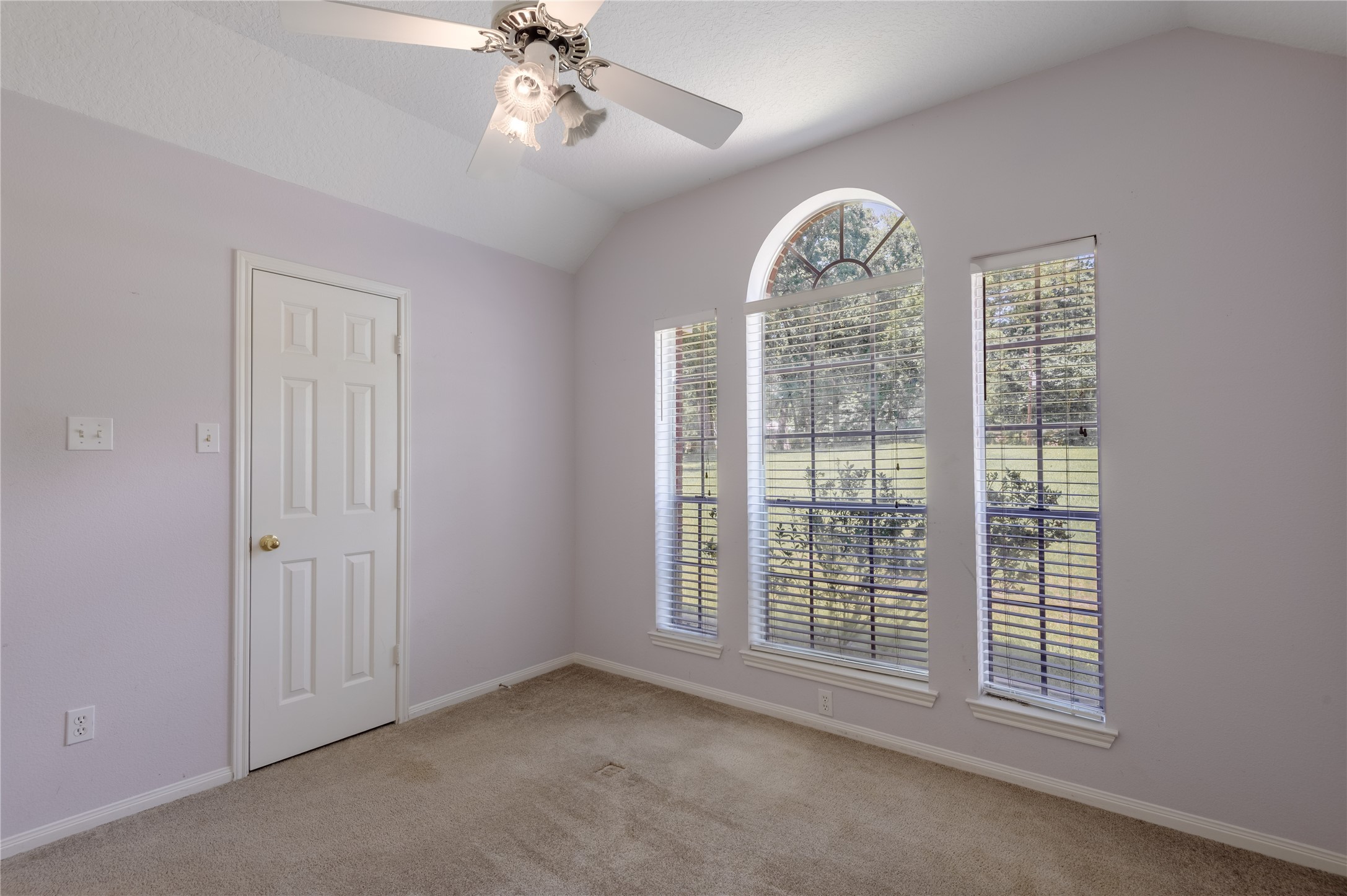324 Red Oak Lane Trinity, TX 75862 - Photo 32 of 49 en empty room with windows and chandelier fan