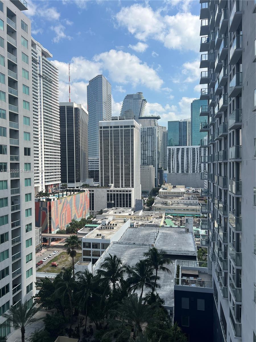 a view of a patio with table and chairs and wooden fence